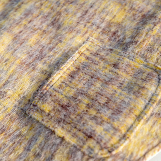 Close-up of functional mini pocket on KIDCORE reversible wool vest, perfect for carrying waste bags or treats